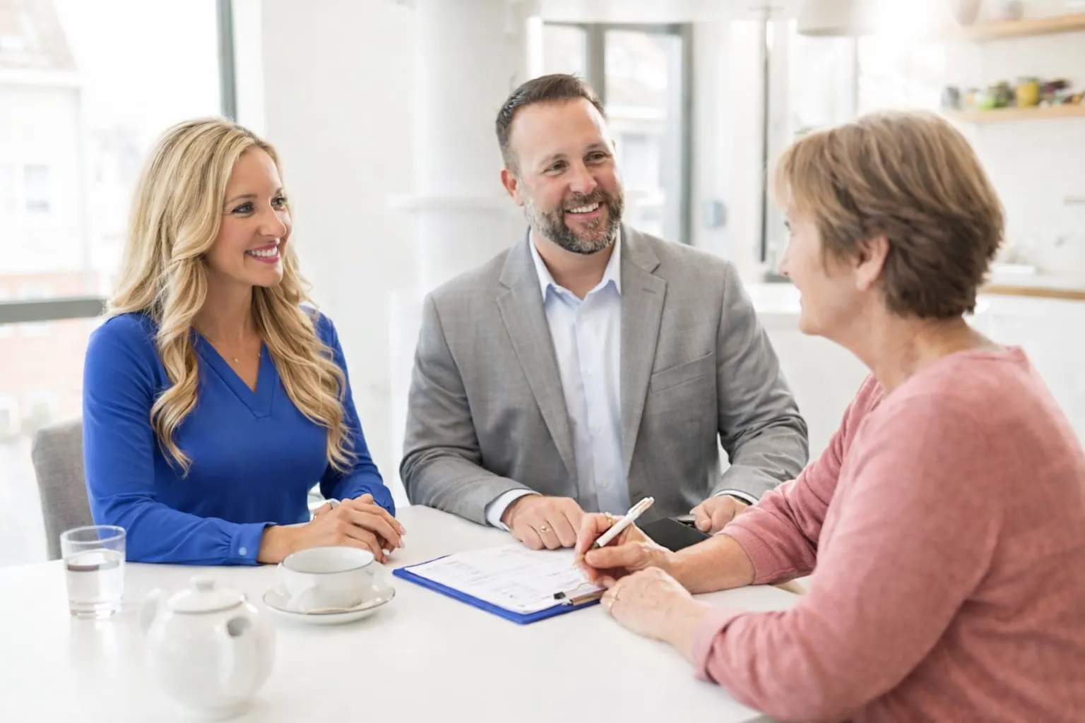 Almond Insurance Medicare advisors speaking with a client at a table in Rockford, IL